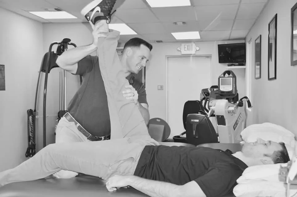 Therapist stretching a patient’s leg