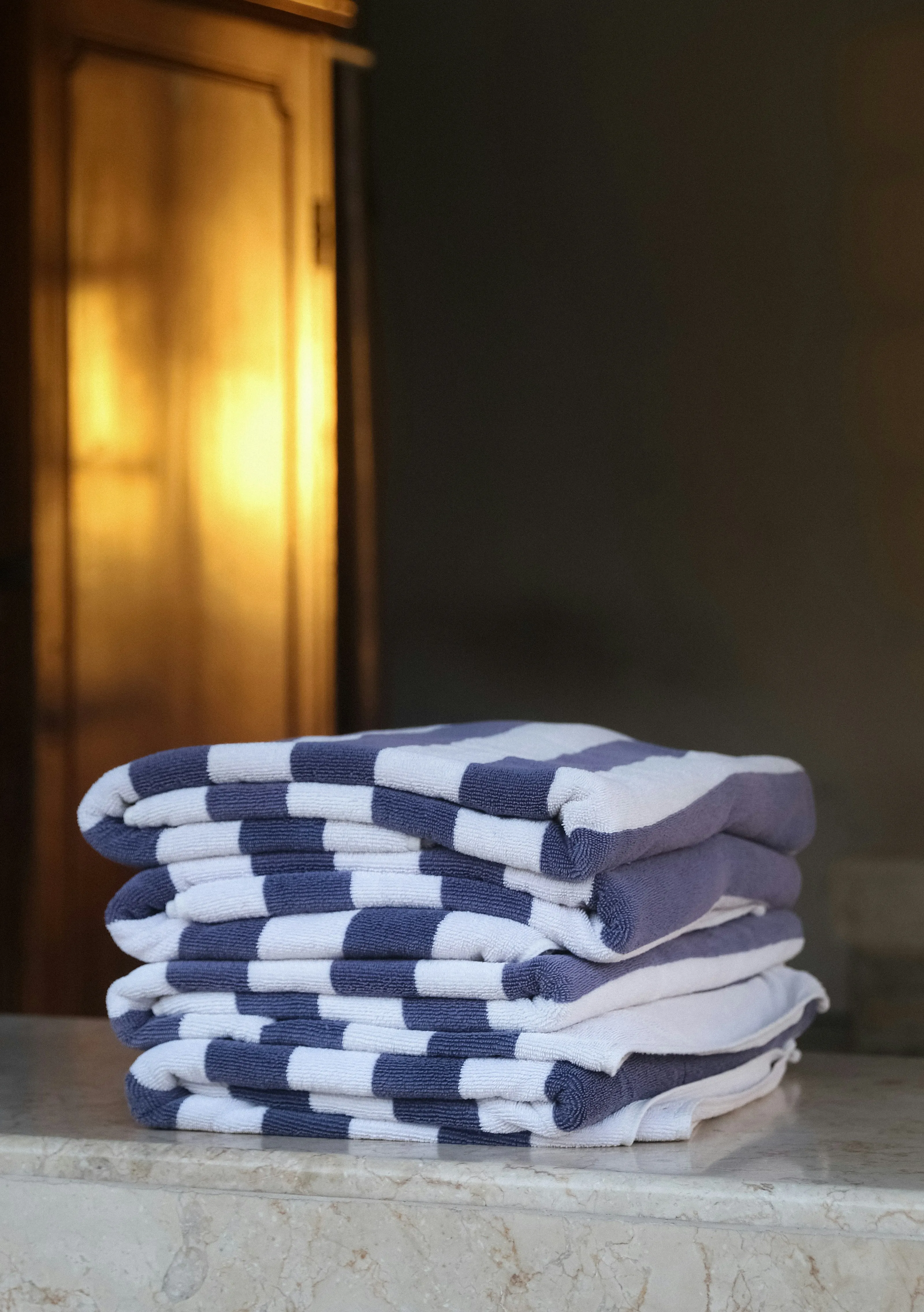 A neat stack of folded striped towels