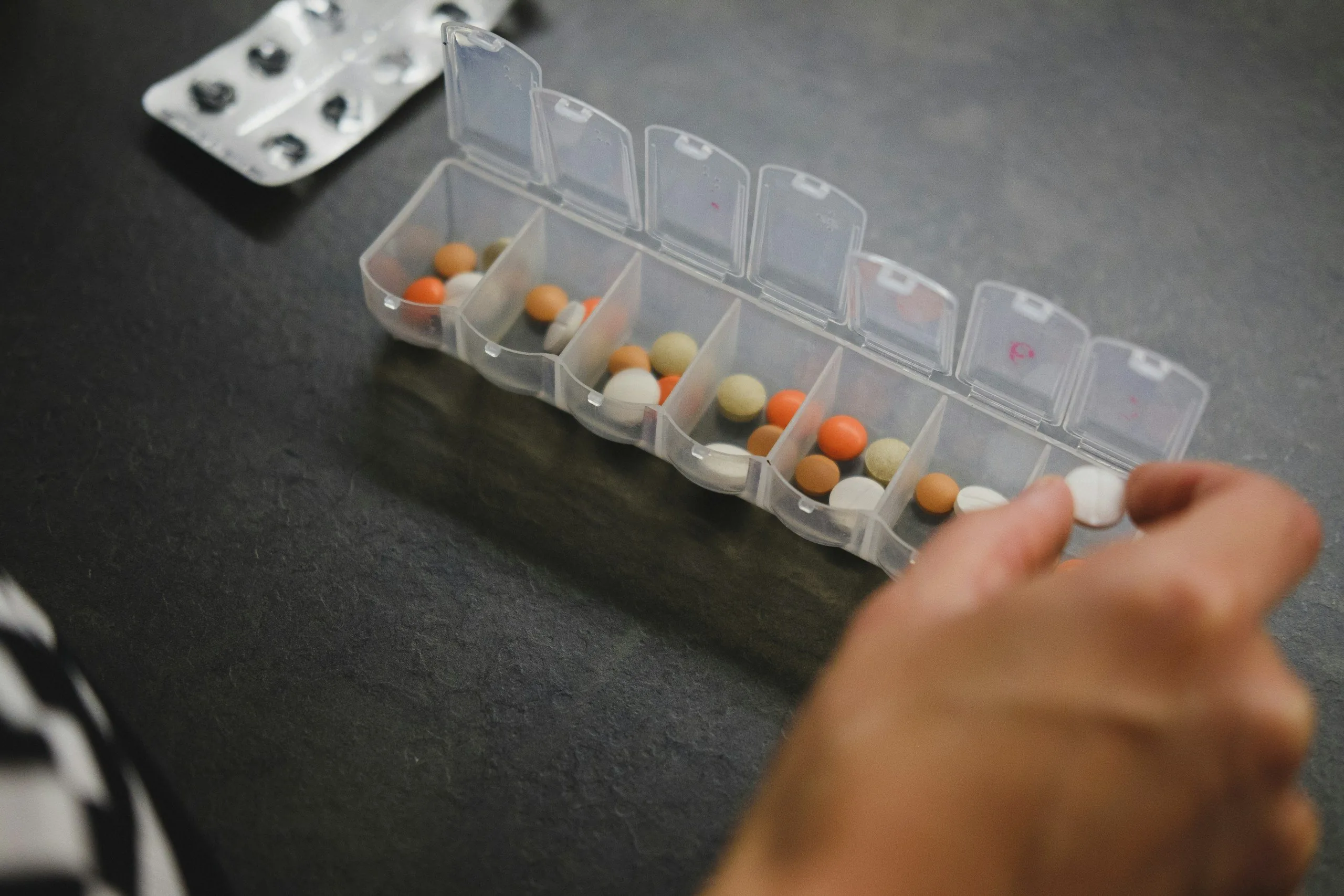 Weekly pill organizer being filled