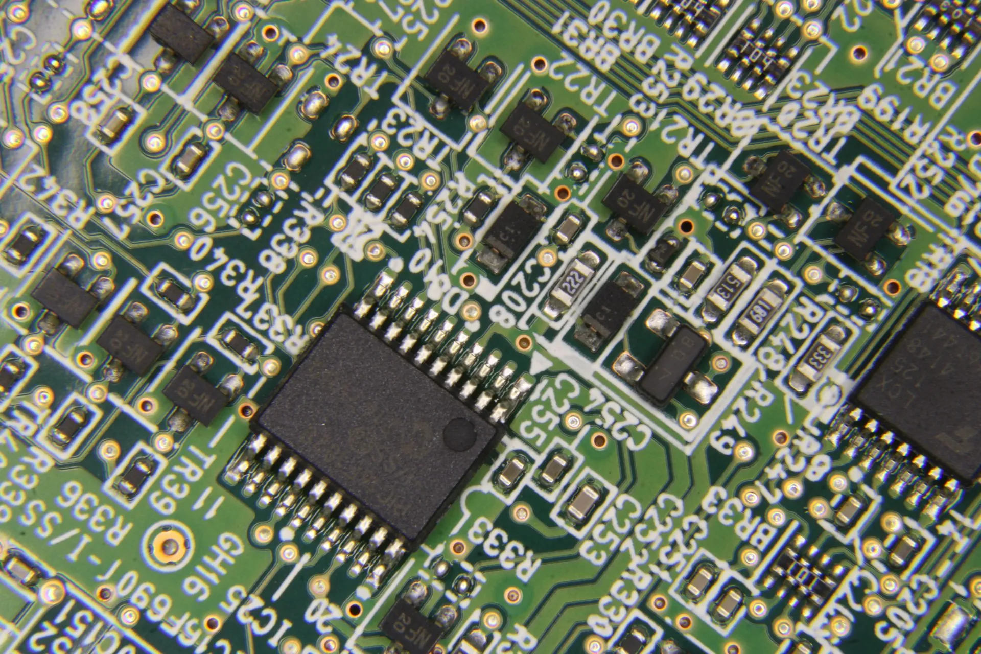 Close-up of a green circuit board under diagnosis
