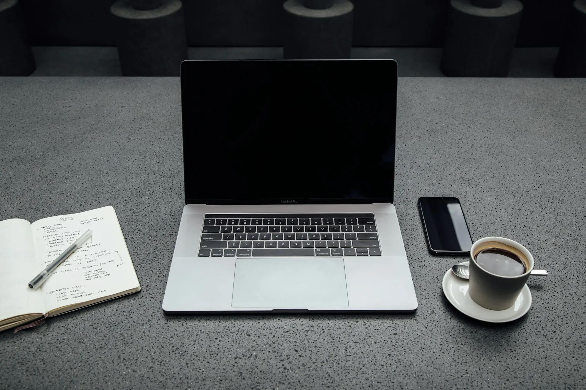 Laptop and notes on a desk during a workspace planning session