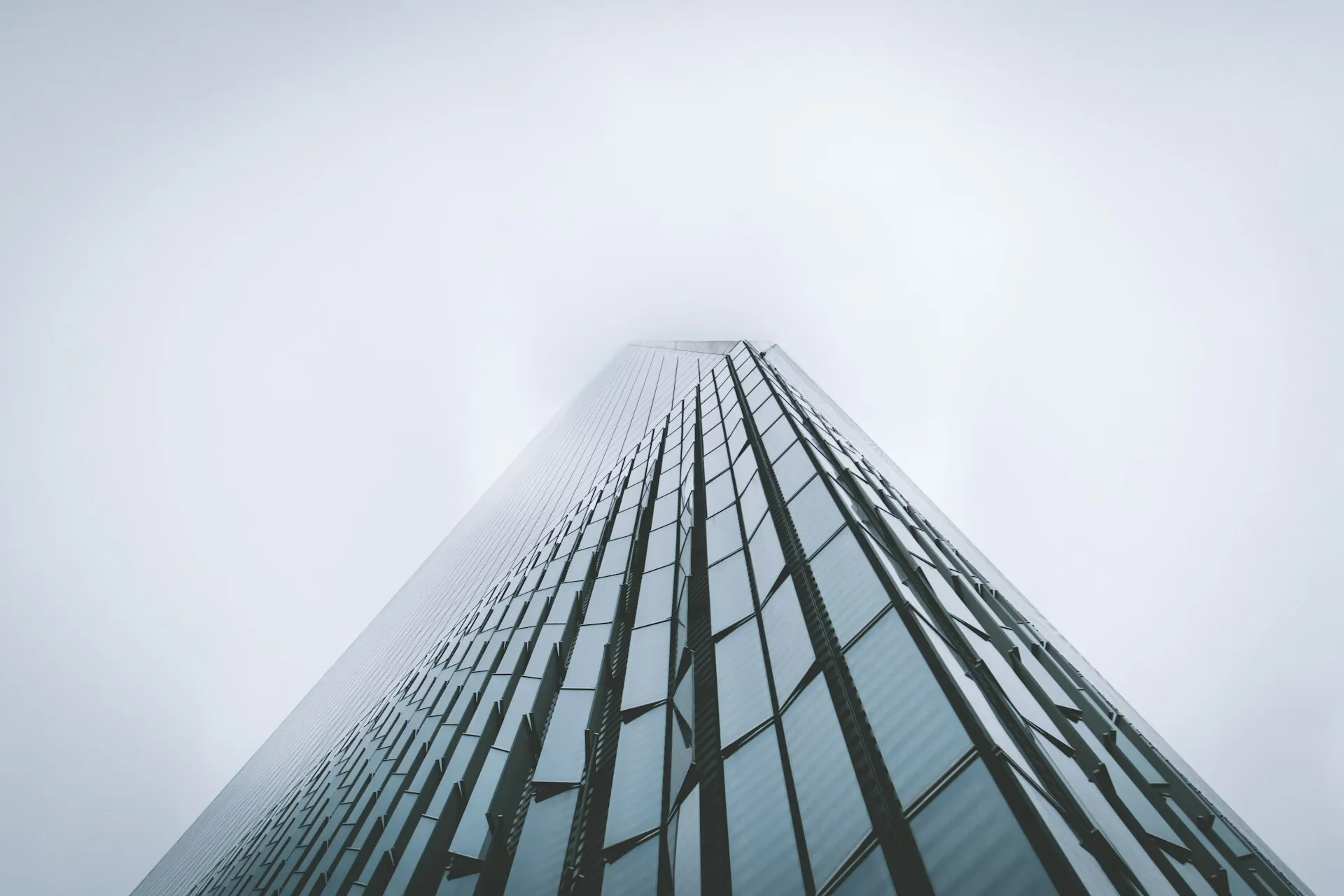 Glass office tower rising into the sky