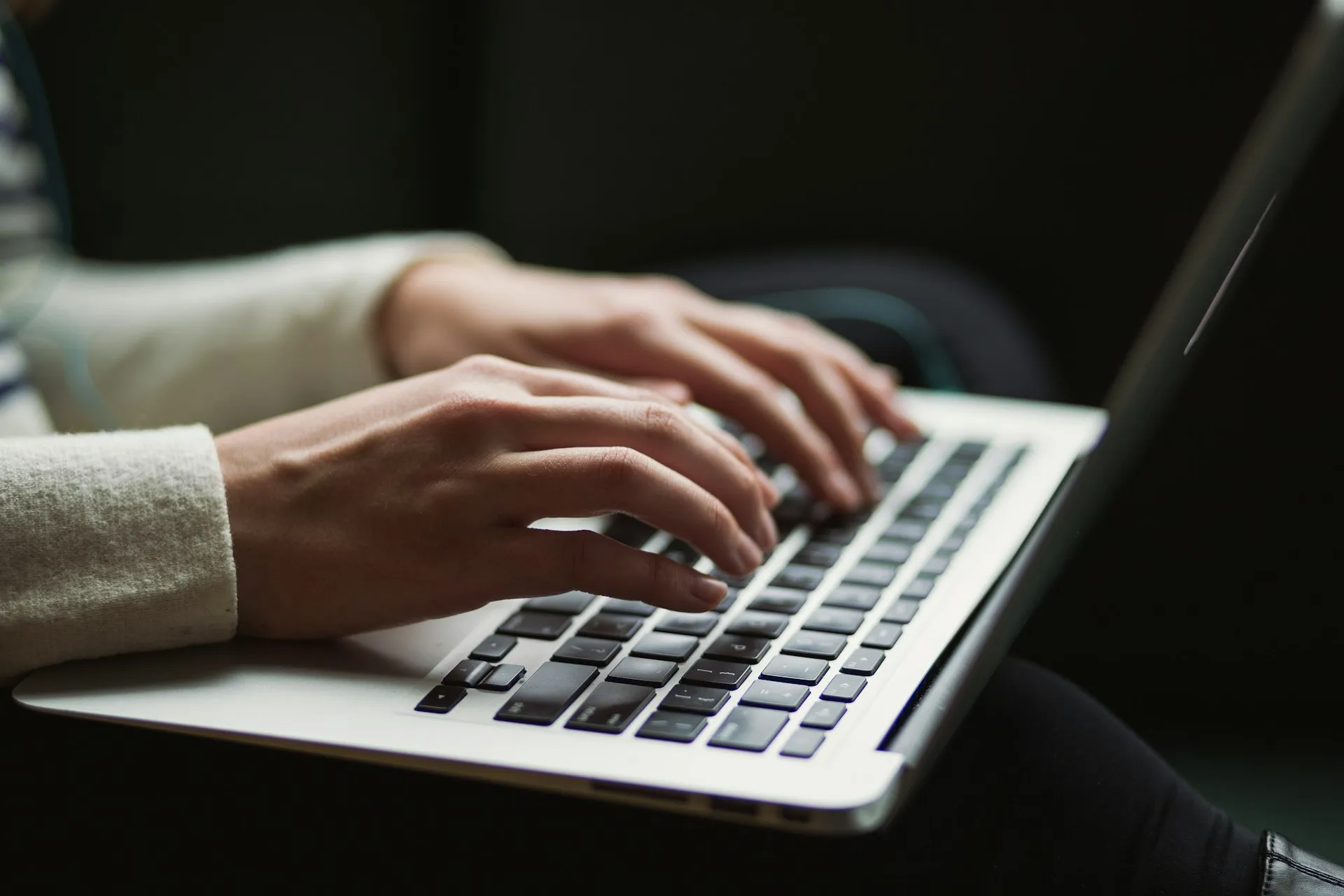 Hands typing at a helpdesk workstation