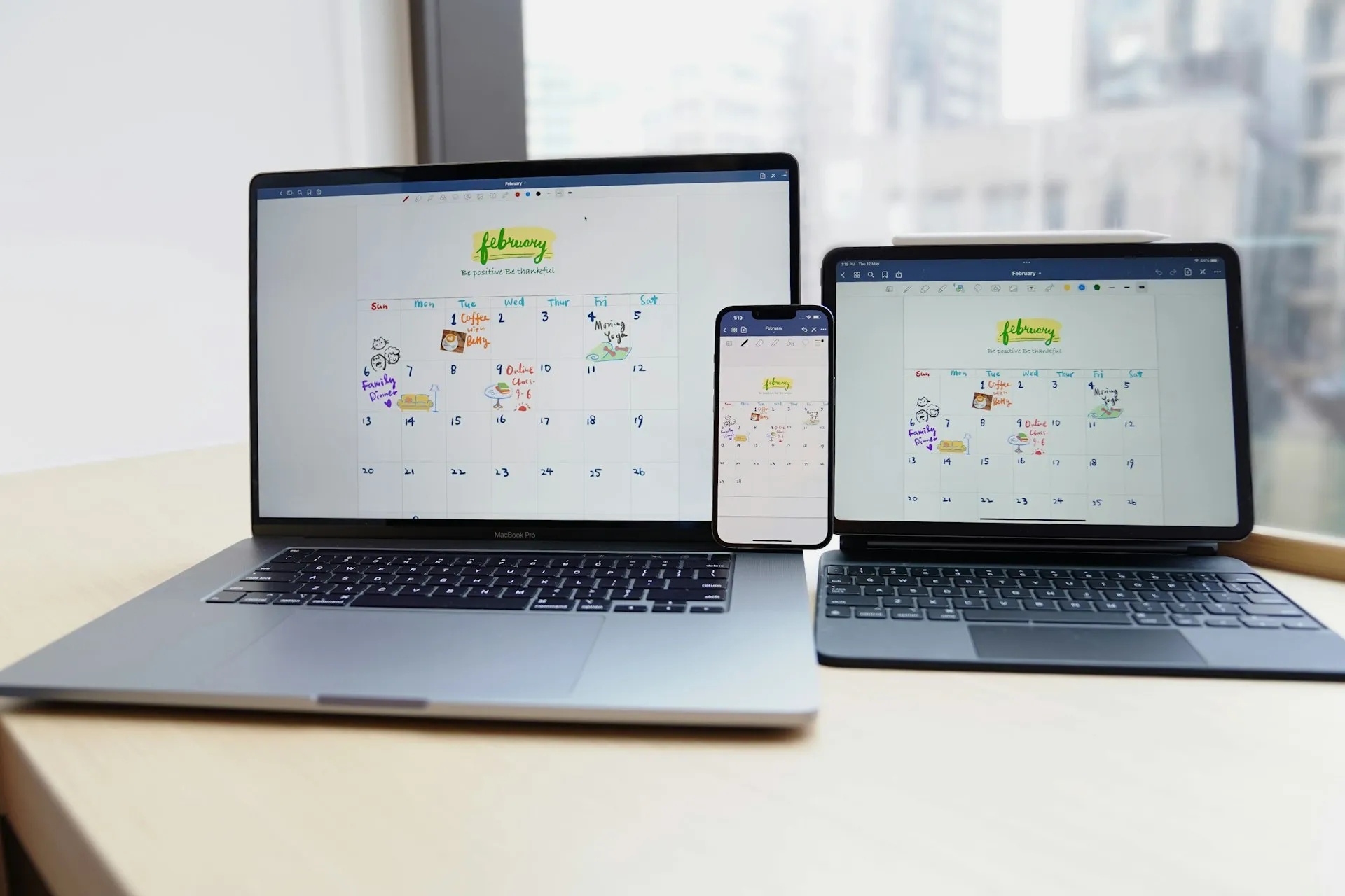 Laptop, tablet and phone showing the same calendar app