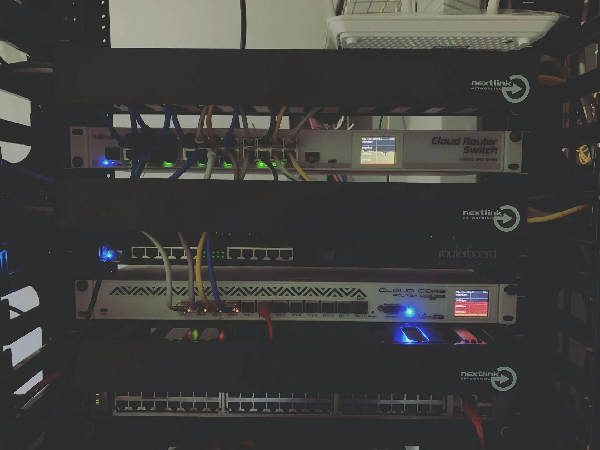 Network rack with routers and switches that link the office to the cloud