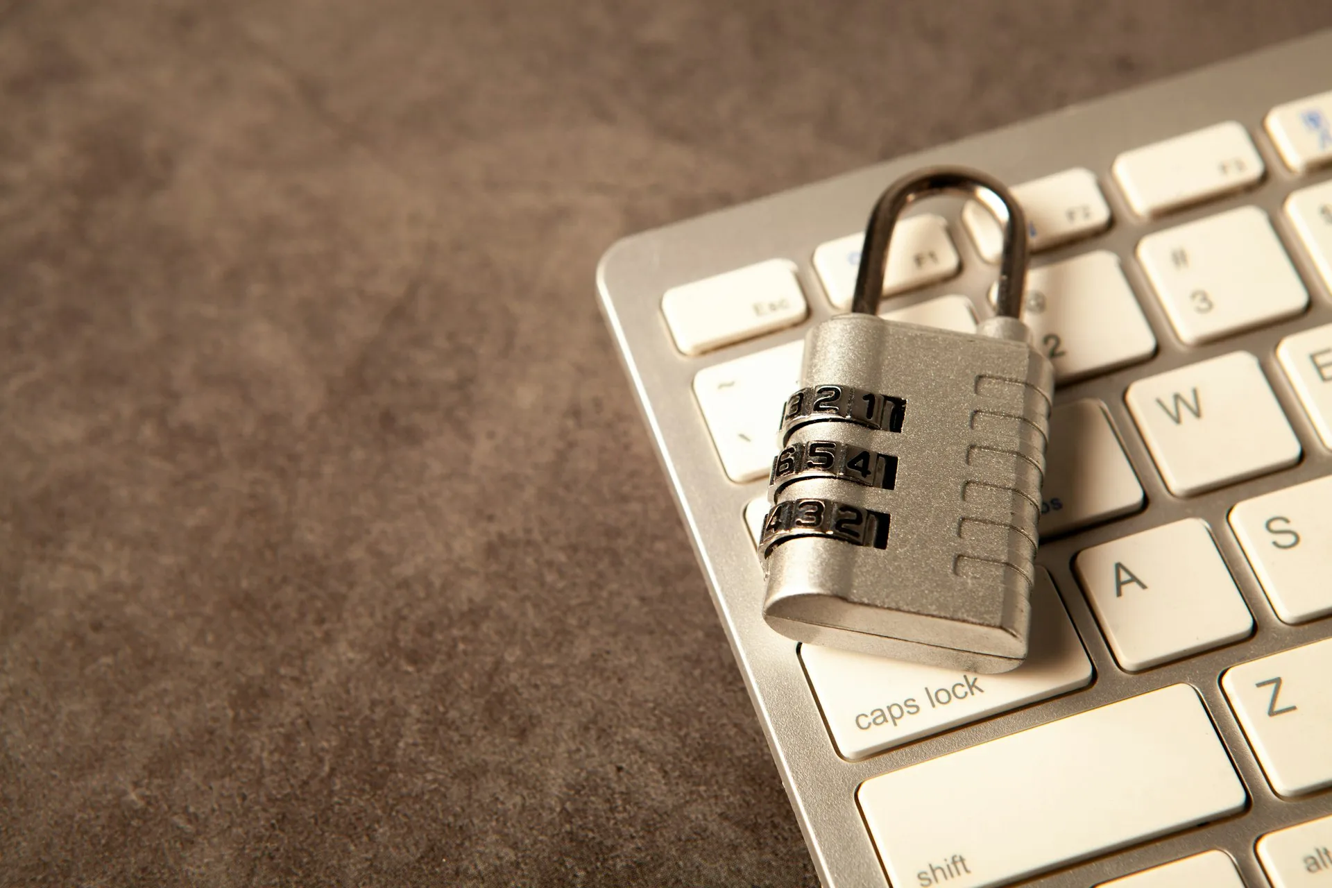 Combination padlock on a laptop keyboard