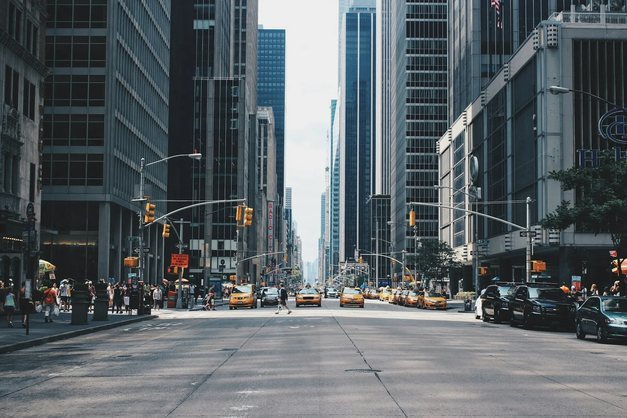 Manhattan avenue with yellow cabs between office towers