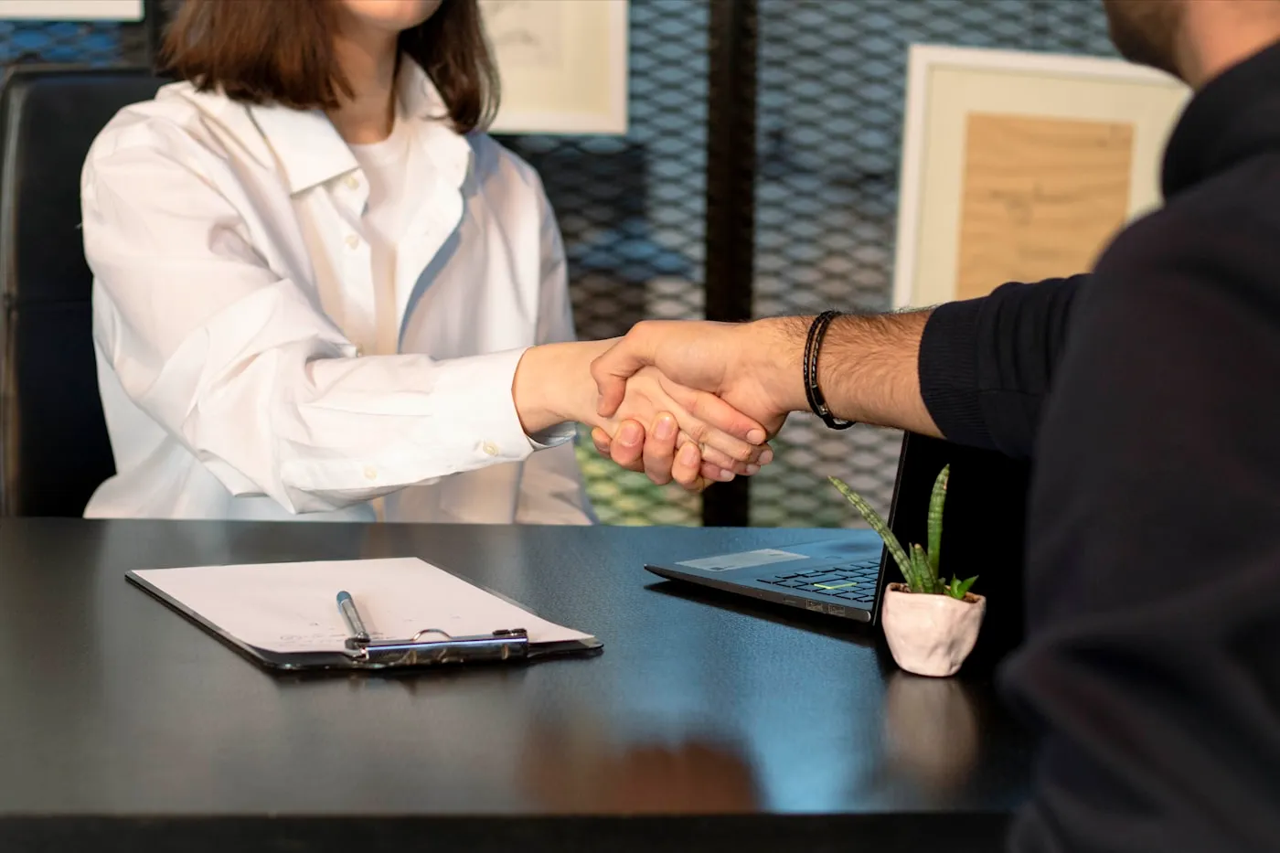 Handshake across a desk, representing IT vendor coordination