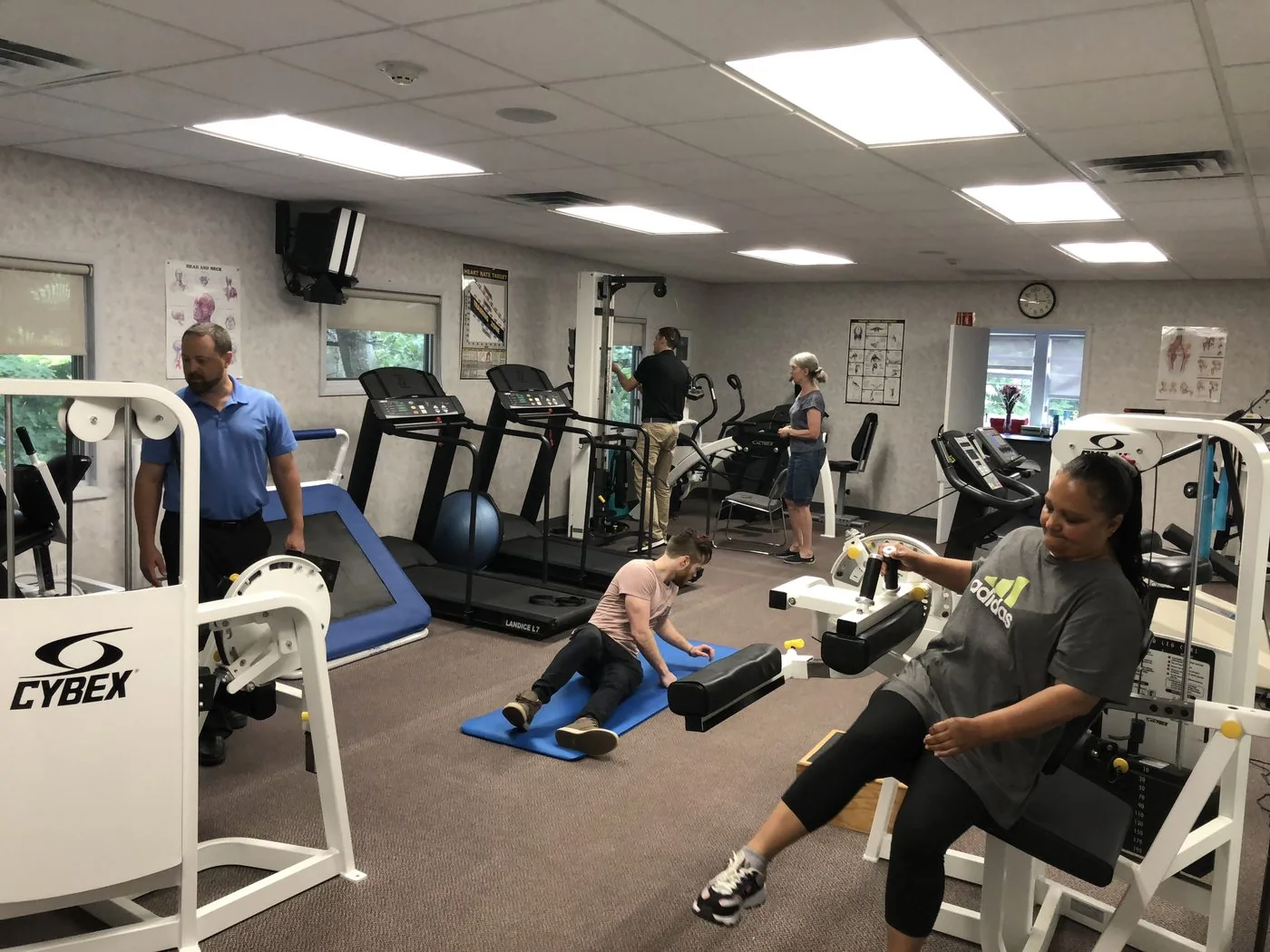 Patients exercising across the clinic floor