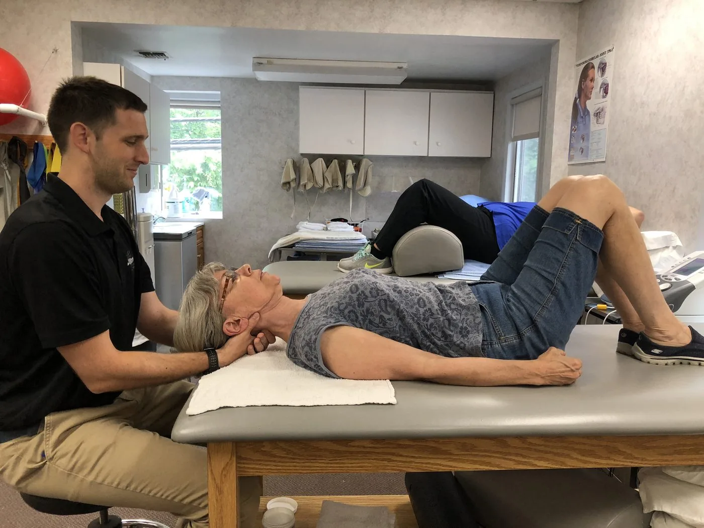Hands-on neck treatment on a therapy table