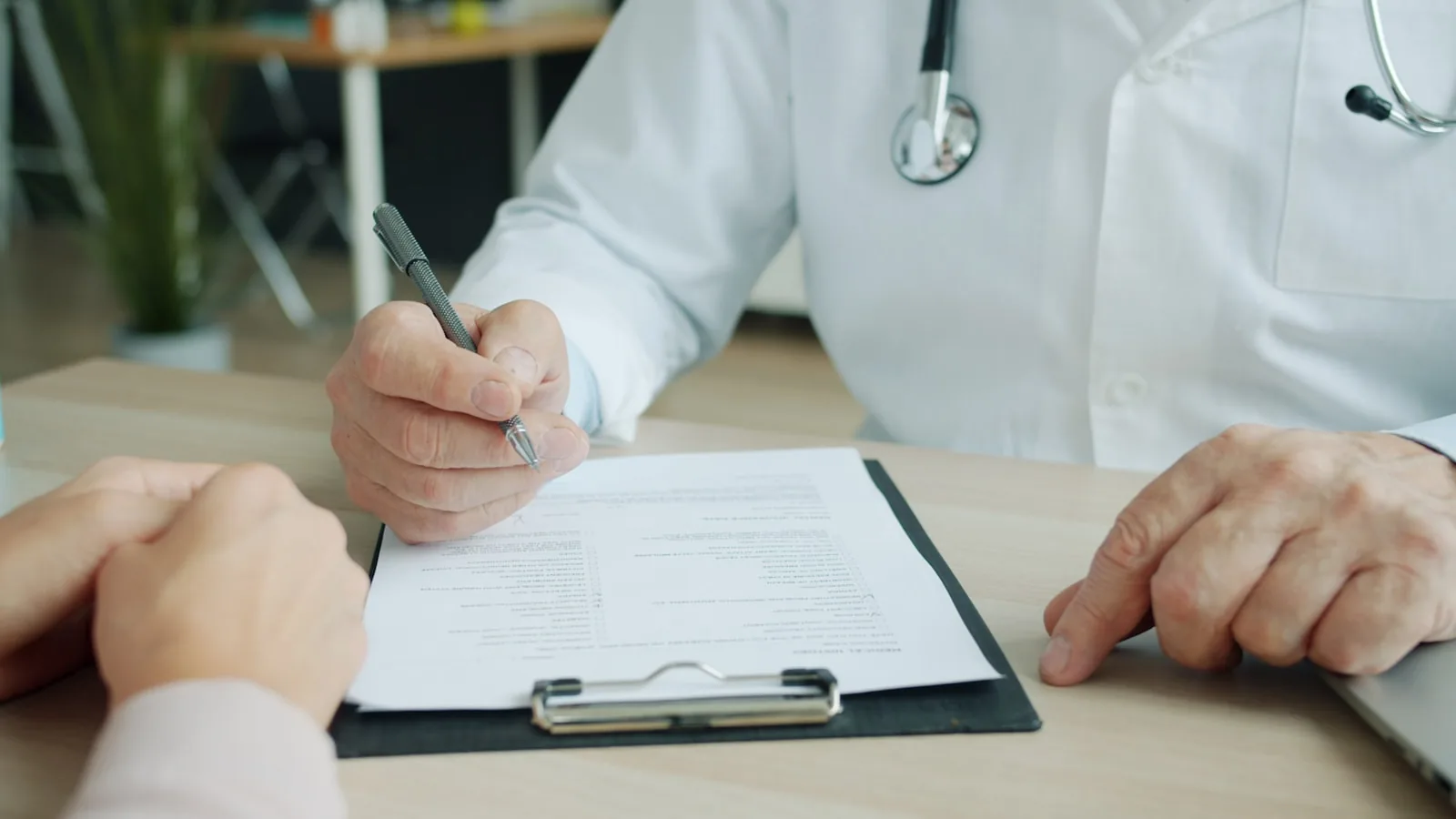 Doctor reviewing medical chart paperwork for case management
